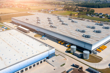 Aerial view of a warehouse of goods. Aerial view of loading and unloading trucks with goods in warehouse