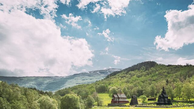 Borgund, Norway. Famous Landmark Stavkirke An Old Wooden Triple Nave Stave Church In Summer Day. Bright Summer Sun Shines Over The Ancient Old Wooden Worship. Norwegian Countryside Landscape.