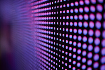 Bright colored blue LED wall with pink pattern - close up background.