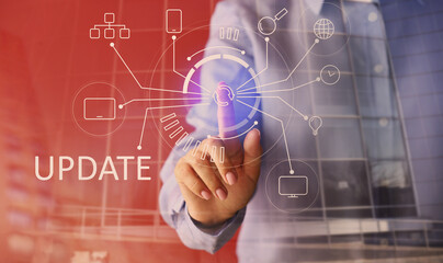 Businesswoman using virtual screen with word UPDATE on red background, closeup
