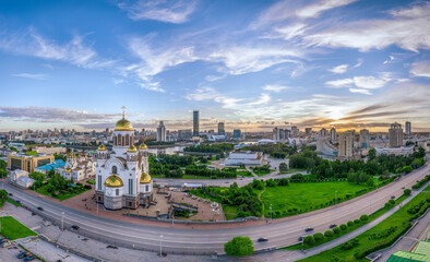 Naklejka premium Summer Yekaterinburg and Temple on Blood in cloudy sunset. Aerial view of Yekaterinburg, Russia. Translation of the text on the temple: Honest to the Lord is the death of His saints.