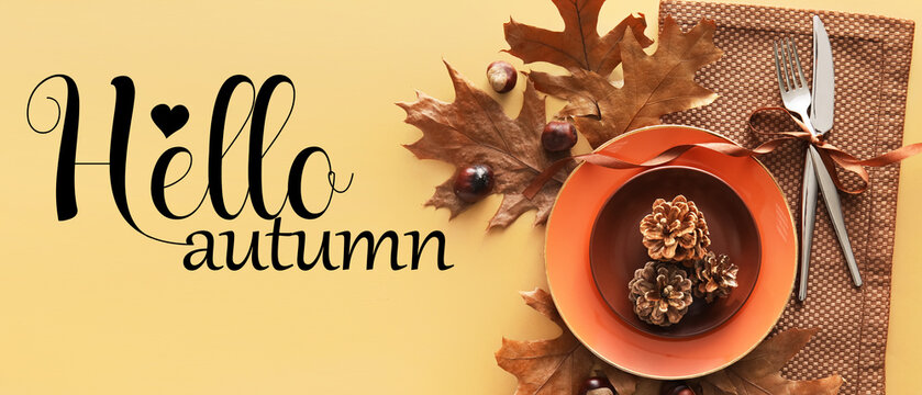 Stylish table setting and text HELLO AUTUMN on color background