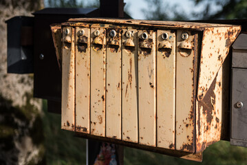 Lots of old, yellow, rusty metal mailboxes.