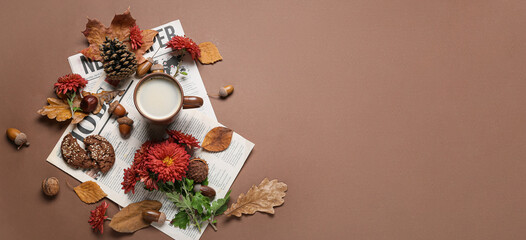 Obraz na płótnie Canvas Composition with cup of coffee, newspapers, flowers and autumn leaves on brown background with space for text, top view