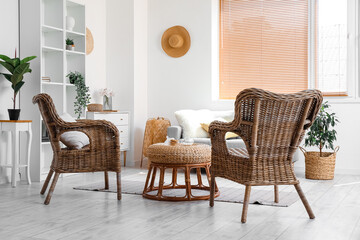Interior of cozy living room with rattan armchairs and table