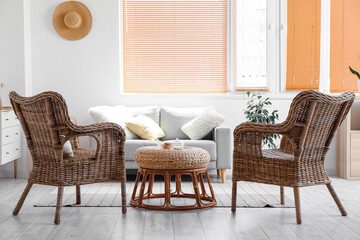 Interior of cozy living room with rattan armchairs and table