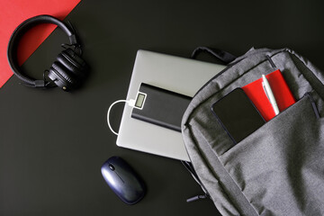 Small gray urban backpack for laptop and gadgets with smartphone, power bank, notepad, pen and...