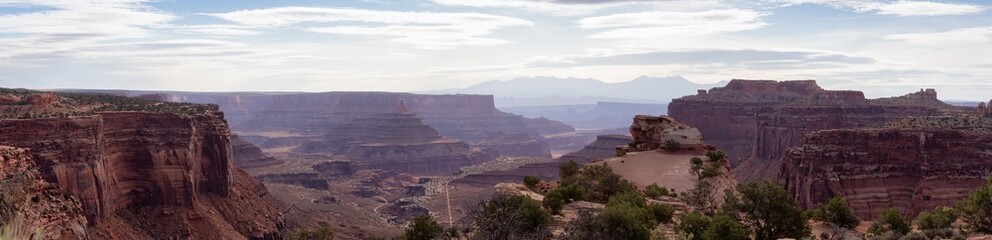 Scenic Panoramic View of American Landscape and Red Rock Mountains in Desert Canyon. Cloudy Sky. Canyonlands National Park. Utah, United States. Nature Background Panorama