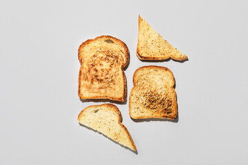 Slices of toasted bread on light background