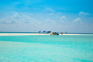 beach in the maldives island and speedboat in turquoise color