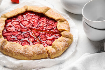 Sweet strawberry galette on light table, closeup