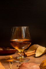 Rum, international rum day in autumn time, with dry leaves on wooden table