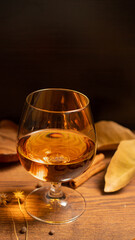 Rum, international rum day in autumn time, with dry leaves on wooden table