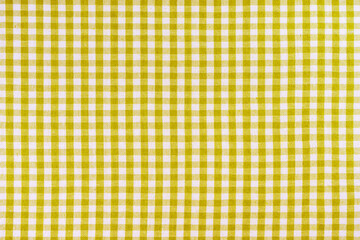 Yellow classic checkered tablecloth texture, background with copy space. Background texture...