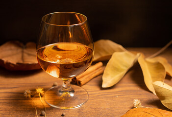 Rum, international rum day in autumn time, with dry leaves on wooden table