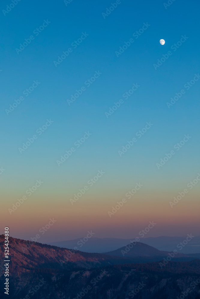 Wall mural dramatic sunset sky on crater lake national park in oregon with silhouette of surrounding mountain p