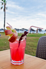 An ice cold rose cocktail with apple in the evening on the beach in turkey
