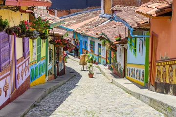 Fototapeten colorful street of guatape colonial town, colombia © jon_chica