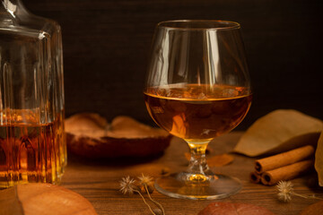 Rum, international rum day in autumn time, with dry leaves on wooden table