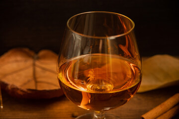 Rum, international rum day in autumn time, with dry leaves on wooden table