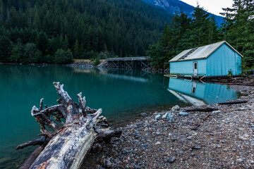 sunrise in still turquoise water of Thunder Arm in Diablo lake in Colonial Creek Campground in North Cascade National park, Washington