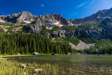 serene Cutthroat Lake in North cascade national park under a clear blue sky in Washington State.