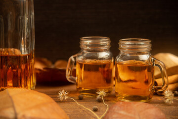 Rum, international rum day in autumn time, with dry leaves on wooden table