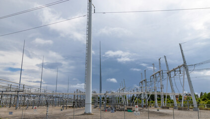 View inside of an electrical utility transformer station showing high voltage lines, pylons,...