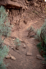 Obraz na płótnie Canvas Faint Trail Leads Along Rocky Desert Cliff