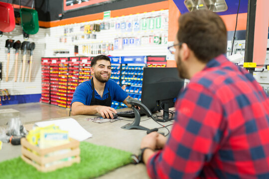 Hardware store worker looking cheerful while giving customer assistance