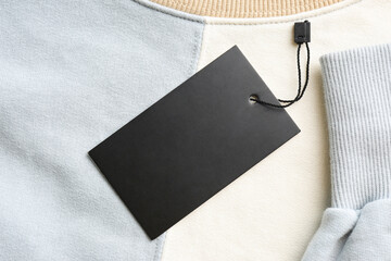 Blank tag on sweatshirt, top view. Space for text
