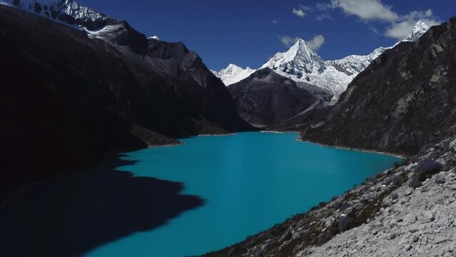 Aerial Shot Ascending The Valley Slope At Laguna Parón With The Snow-capped Paramount Pictures Mountain