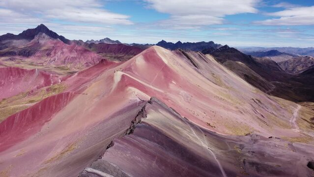 Forward aerial shot of mountains with red ore on the seven colored mountain in Vinicunca