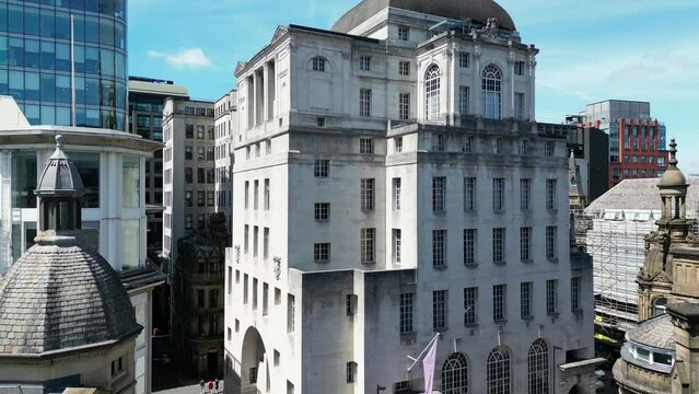 Aerial drone flight slowly rising to the rooftop of the Gotham Hotel in Manchester City Centre showing off some Gothic architechture and modern apartments