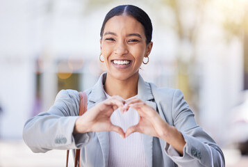 Love, heart and happy hand sign of a young female with a smile with a positive mindset and vision. Portrait of a modern business woman smiling with a hands gesture showing support, trust and care