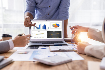 Financial analysts analyze business financial reports on a digital tablet planning investment project during a discussion at a meeting of corporate showing the results of their successful teamwork.