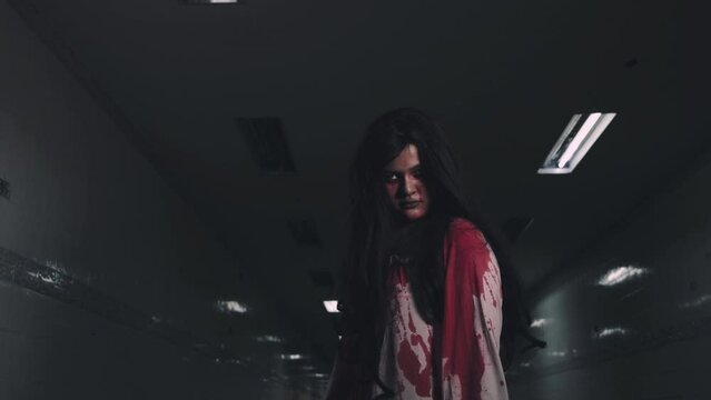 Bloody halloween makeup. Horror bloodthirsty ghost girl walking reach arm out, Asian woman zombie with blood she death and scary walk hope to kill at night in tunnel, Happy halloween day concept