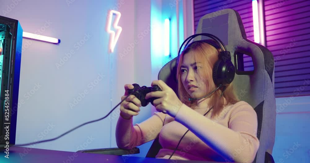 Aufkleber you win. gamer using joystick controller plays online video game with computer neon lights she winni