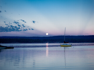 Sail Boat on a Lake with an Early Morning Moon
