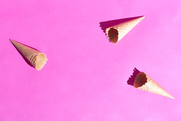Group of waffle cones on pink colour paper background