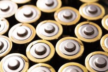 Closeup of positive ends of discharged batteries AA sizes, selective focus. Used alkaline battery. Hazardous garbage concept