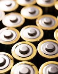 Obraz premium Closeup of positive ends of discharged batteries AA sizes, selective focus. Used alkaline battery. Hazardous garbage concept