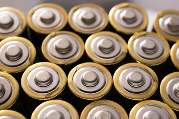 Closeup of positive ends of discharged batteries AA sizes, selective focus. Used alkaline battery. Hazardous garbage concept