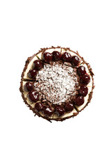 Top view of chocolate cake topping with red berries, cream and icing