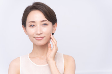 Skin care. Woman with beauty face touching healthy facial skin portrait. Asian woman. 