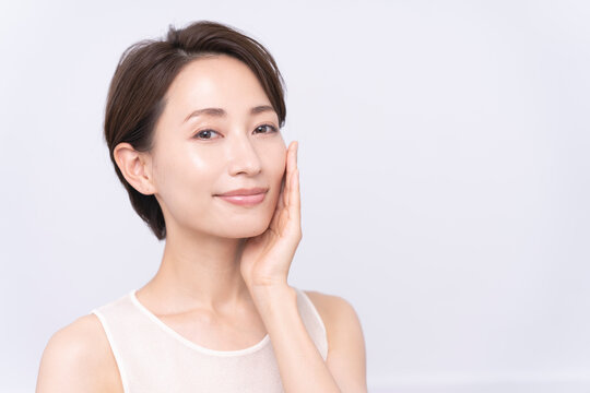 Skin care. Woman with beauty face touching healthy facial skin portrait. Asian woman. 