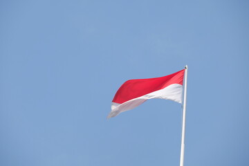 red and white flag on the wind