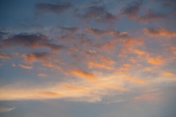 Naklejka na ściany i meble Orange clouds at sunset. Natural sky background. High quality photo