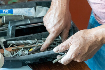 latino man looking for tools in his toolbox, hispanic, with screwdriver in hand