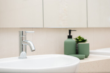 Fototapeta na wymiar Clean shinning water tap faucet in modern bathroom.